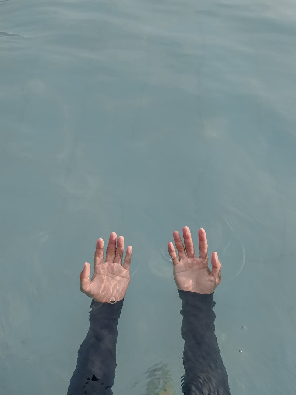 person s hand on water
